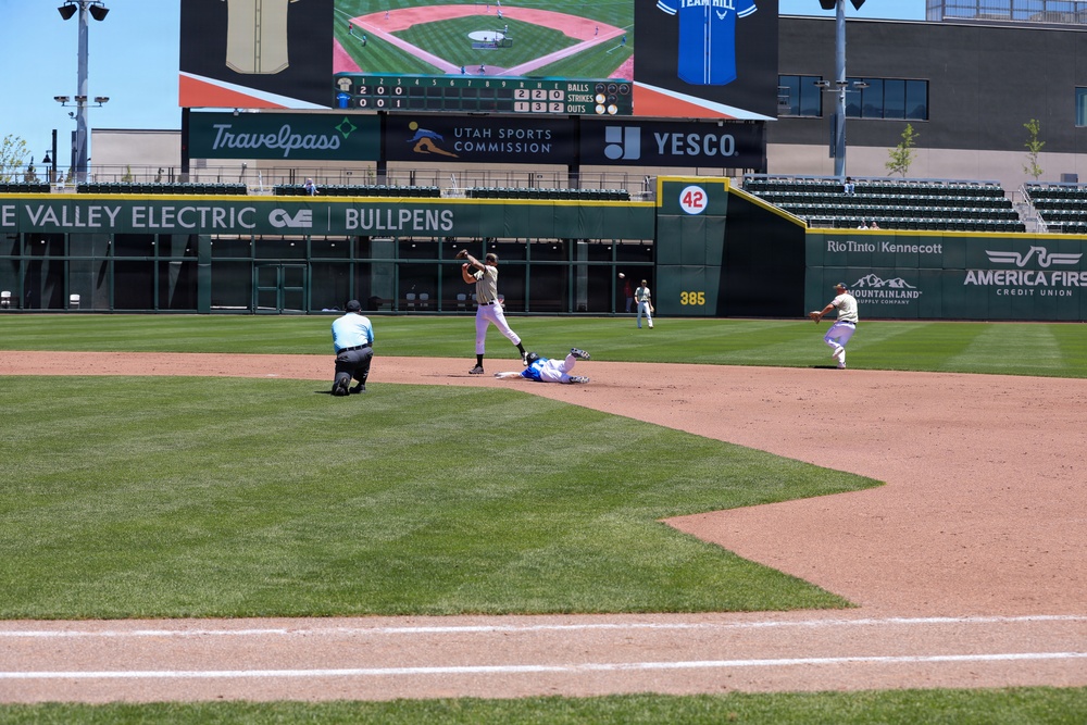 Baseball action at Smith's Ballpark during Utah Sports Commission event with runner sliding into second base
