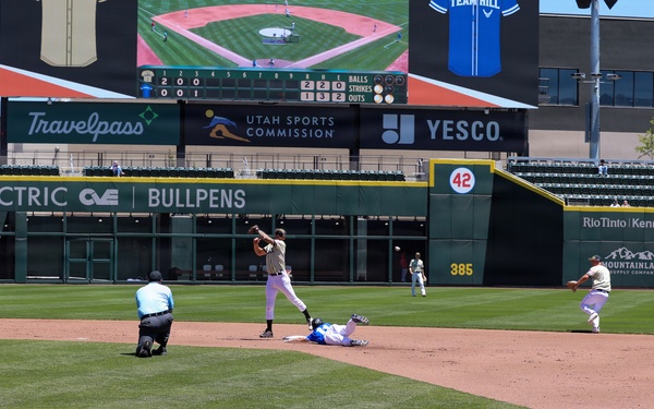 Baseball action at Smith's Ballpark during Utah Sports Commission event with runner sliding into second base