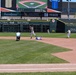 Baseball action at Smith's Ballpark during Utah Sports Commission event with runner sliding into second base