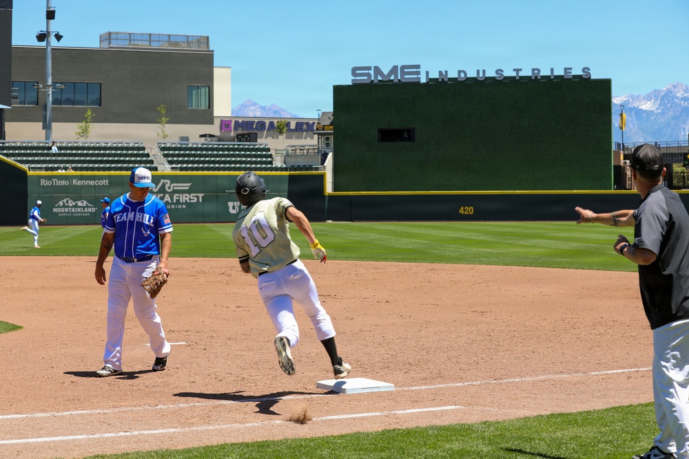 Runner rounds third base during baseball game at Smith's Ballpark in Salt Lake City, Utah