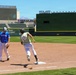 Runner rounds third base during baseball game at Smith's Ballpark in Salt Lake City, Utah