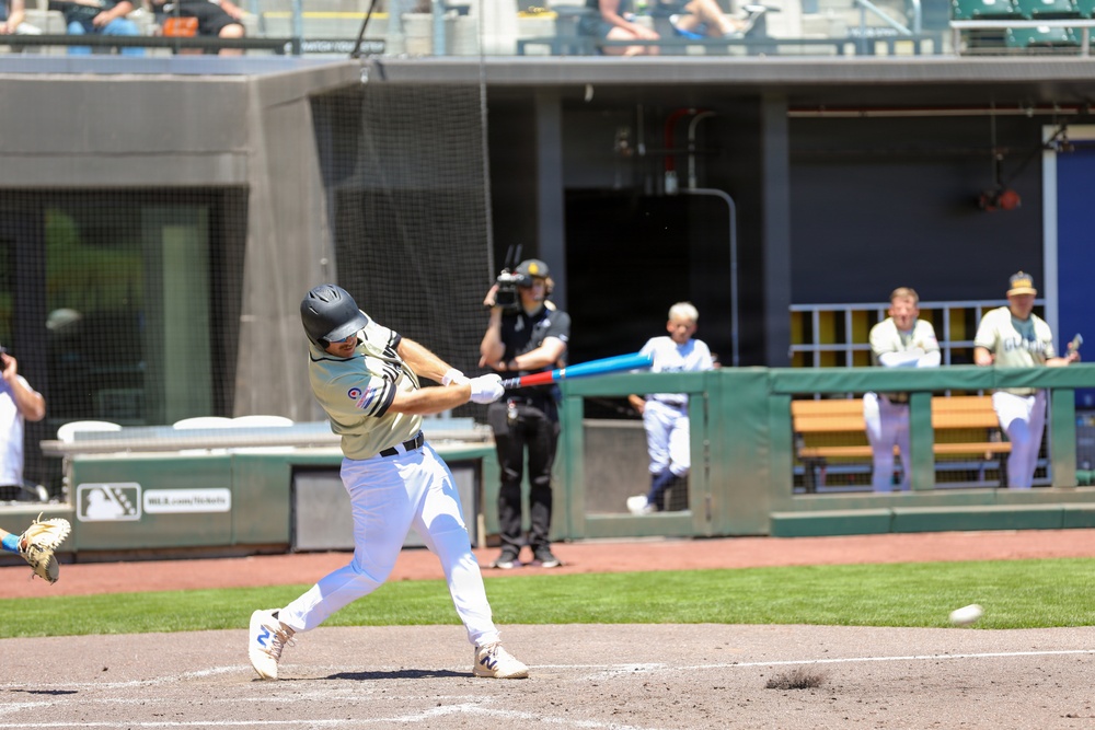 Batter connects during baseball game at professional stadium