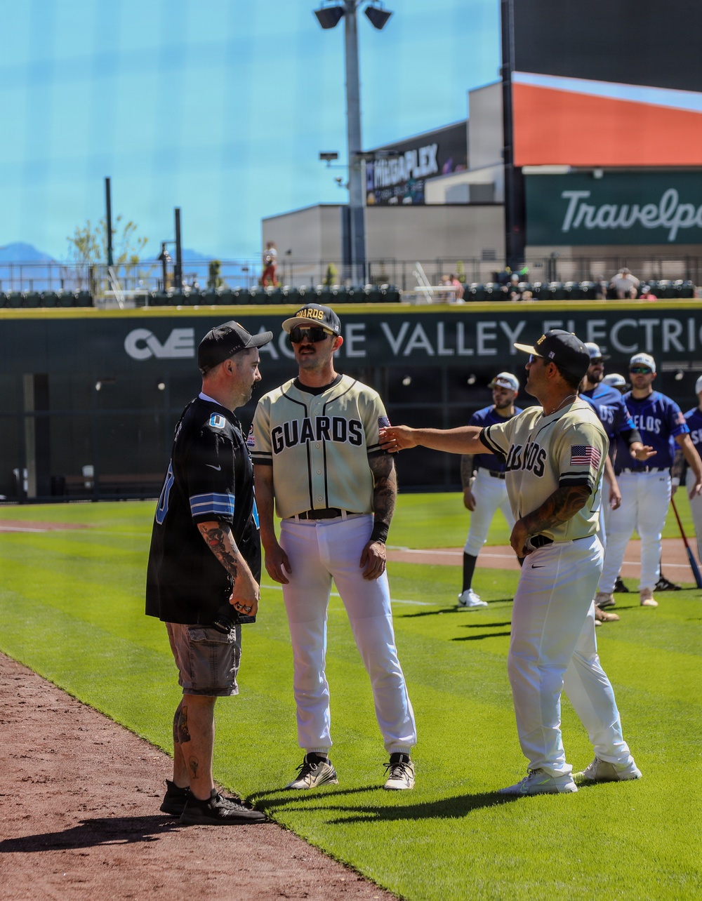 Guards players interact with civilian guest during pre-game ceremonies at Cache Valley Electric ballpark