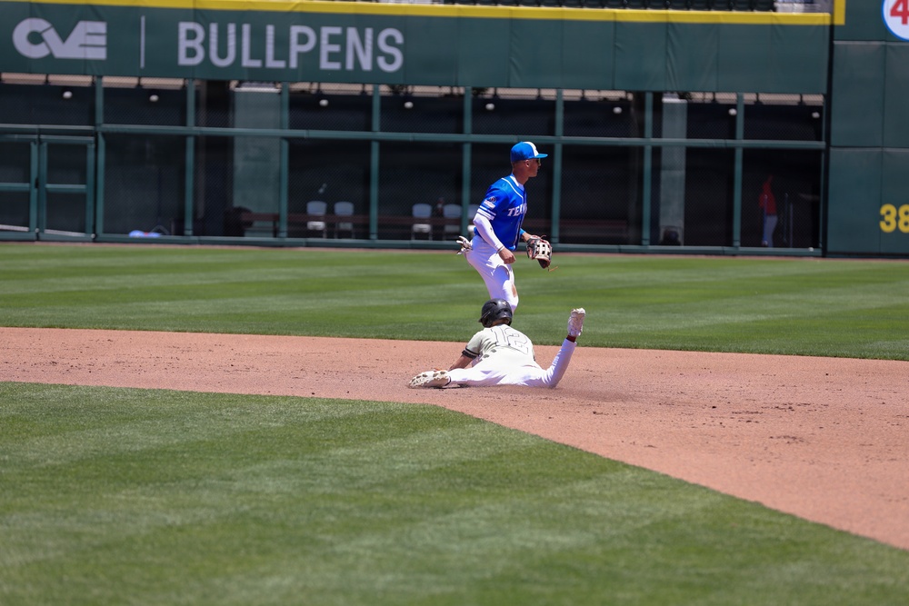 Baserunner slides into second base as infielder completes double-play attempt during baseball game