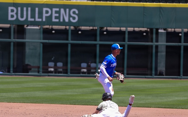 Baserunner slides into second base as infielder completes double-play attempt during baseball game
