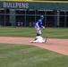 Baserunner slides into second base as infielder completes double-play attempt during baseball game
