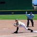 Softball player fields ball at first base during military appreciation game