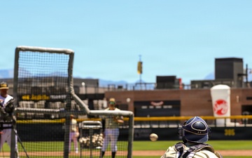 Baseball catcher receives pitch during batting practice at outdoor stadium