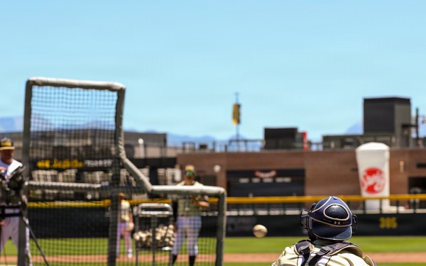 Baseball catcher receives pitch during batting practice at outdoor stadium