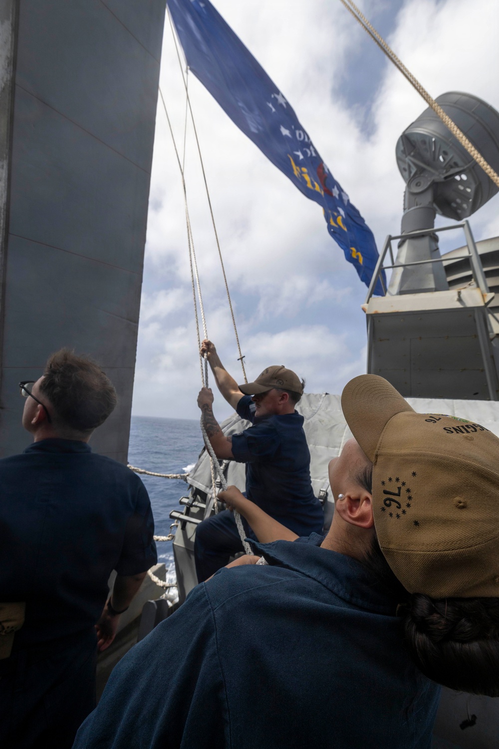 Sailors Raise the Battle Ensign