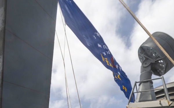 Sailors Raise the Battle Ensign