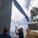 Sailors Raise the Battle Ensign