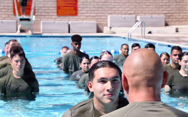 U.S. Marine Corps Sgt. Jorge D. Bosquez and Cpl. Angel F. Cazares reenlist