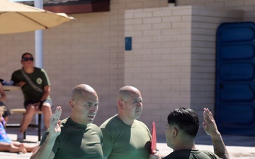 U.S. Marine Corps Sgt. Jorge D. Bosquez and Cpl. Angel F. Cazares reenlist