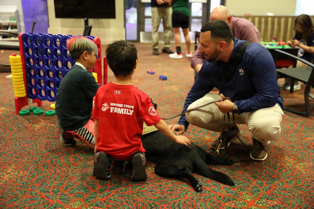 Smoky the therapy dog meets families at 2026 Warrior Games