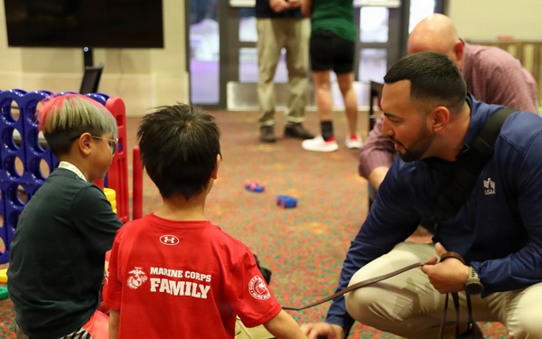 Smoky the therapy dog meets families at 2026 Warrior Games