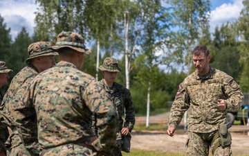 U.S. Marines and Latvian soldiers conduct a decontamination zone in the Baltic region