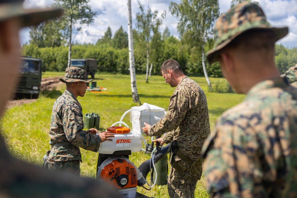 U.S. Marines and Latvian soldiers conduct a decontamination zone in the Baltic region