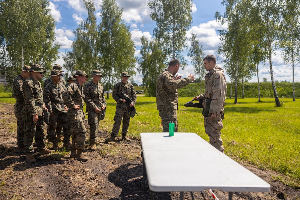U.S. Marines and Latvian soldiers conduct a decontamination zone in the Baltic region