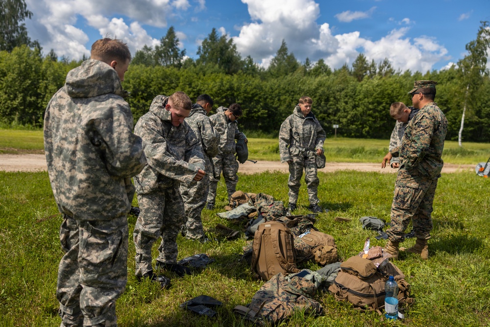 U.S. Marines and Latvian soldiers conduct a decontamination zone in the Baltic region