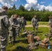 U.S. Marines and Latvian soldiers conduct a decontamination zone in the Baltic region