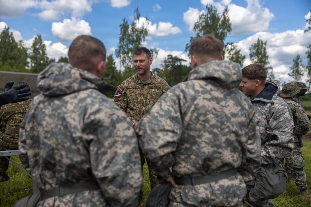 U.S. Marines and Latvian soldiers conduct a decontamination zone in the Baltic region