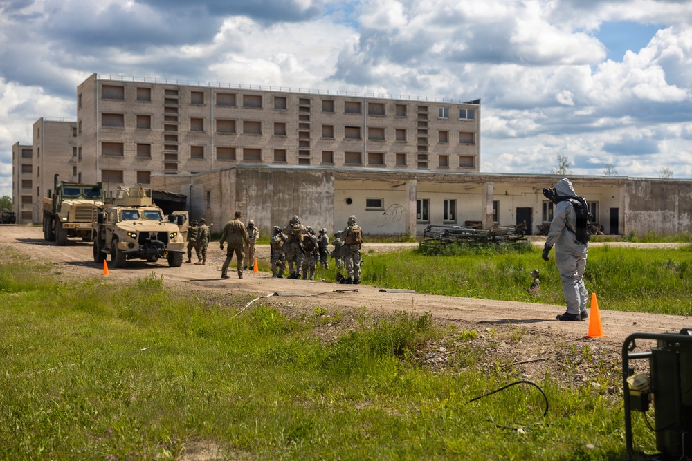 U.S. Marines and Latvian soldiers conduct a decontamination zone in the Baltic region
