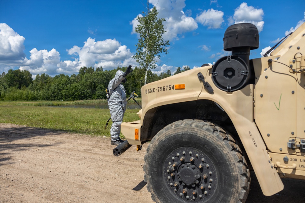U.S. Marines and Latvian soldiers conduct a decontamination zone in the Baltic region