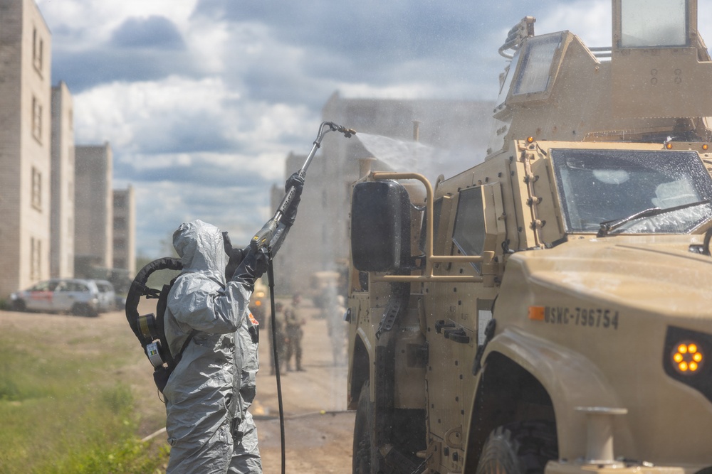 U.S. Marines and Latvian soldiers conduct a decontamination zone in the Baltic region