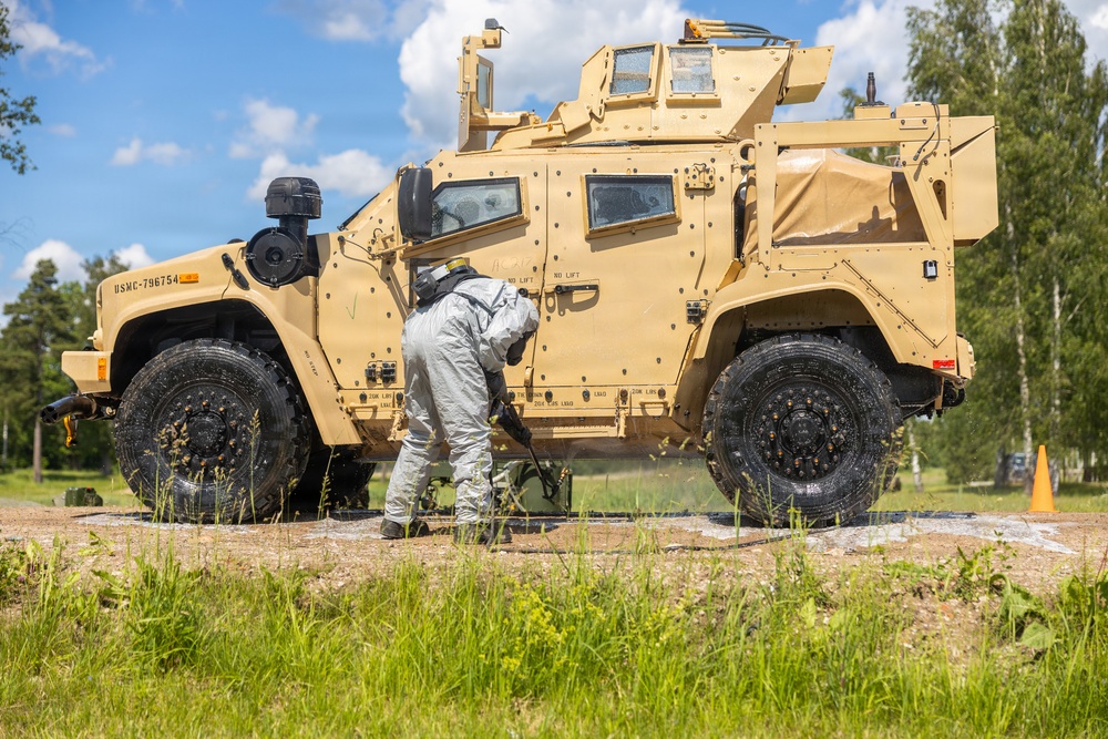 U.S. Marines and Latvian soldiers conduct a decontamination zone in the Baltic region