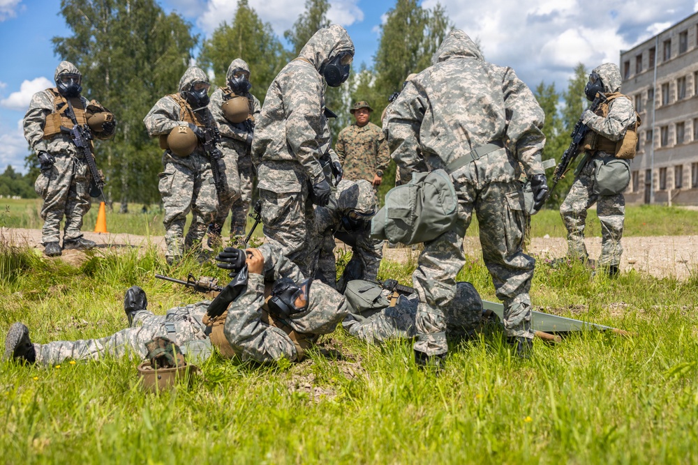 U.S. Marines and Latvian soldiers conduct a decontamination zone in the Baltic region
