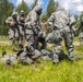 U.S. Marines and Latvian soldiers conduct a decontamination zone in the Baltic region
