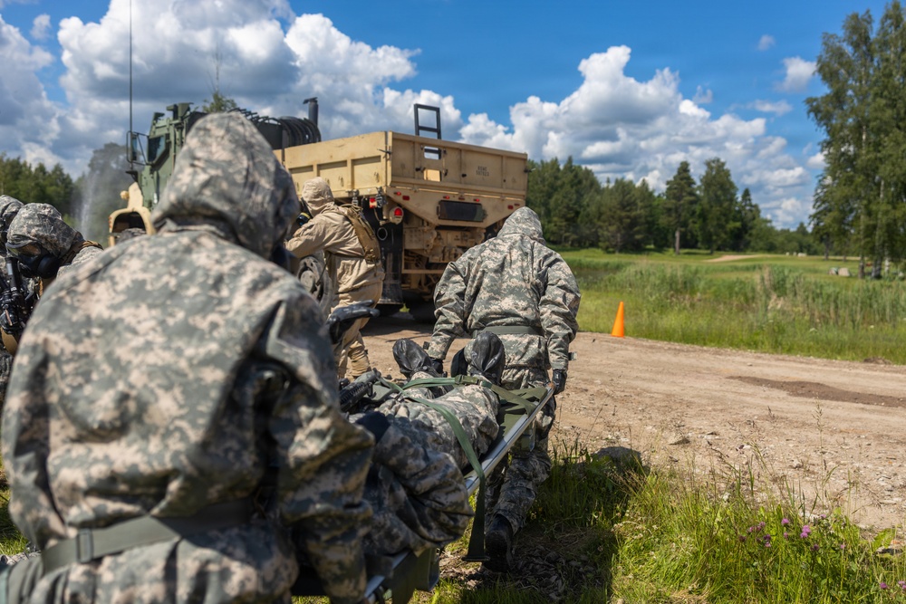 U.S. Marines and Latvian soldiers conduct a decontamination zone in the Baltic region