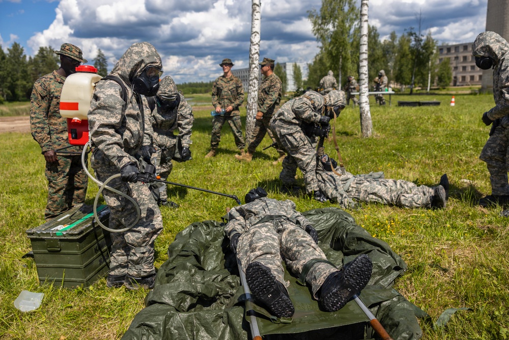 U.S. Marines and Latvian soldiers conduct a decontamination zone in the Baltic region