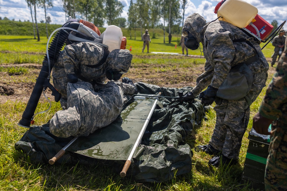 U.S. Marines and Latvian soldiers conduct a decontamination zone in the Baltic region