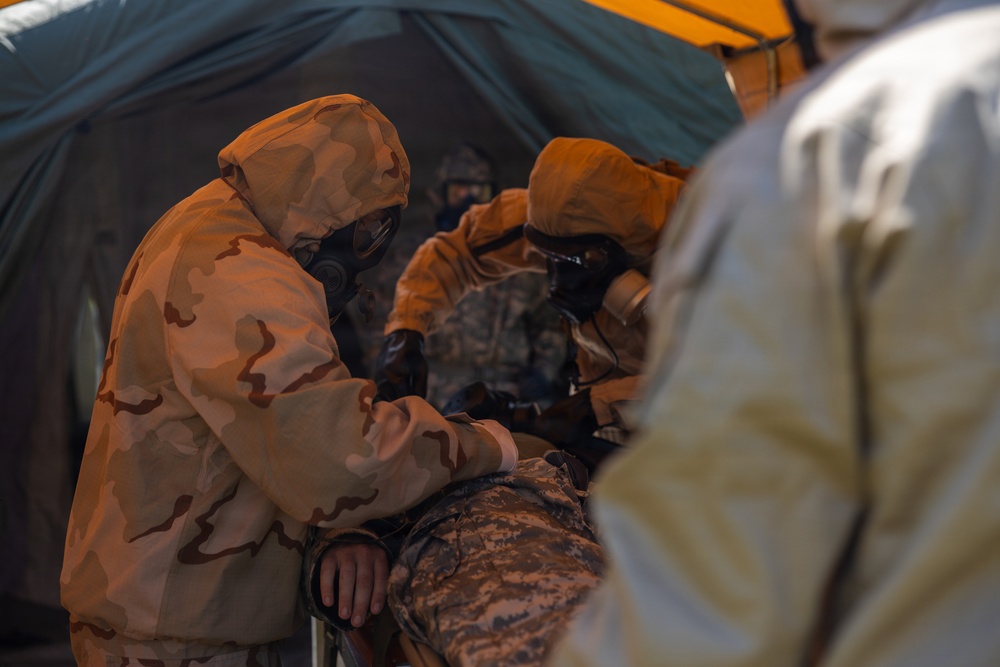 U.S. Marines and Latvian soldiers conduct a decontamination zone in the Baltic region