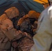 U.S. Marines and Latvian soldiers conduct a decontamination zone in the Baltic region