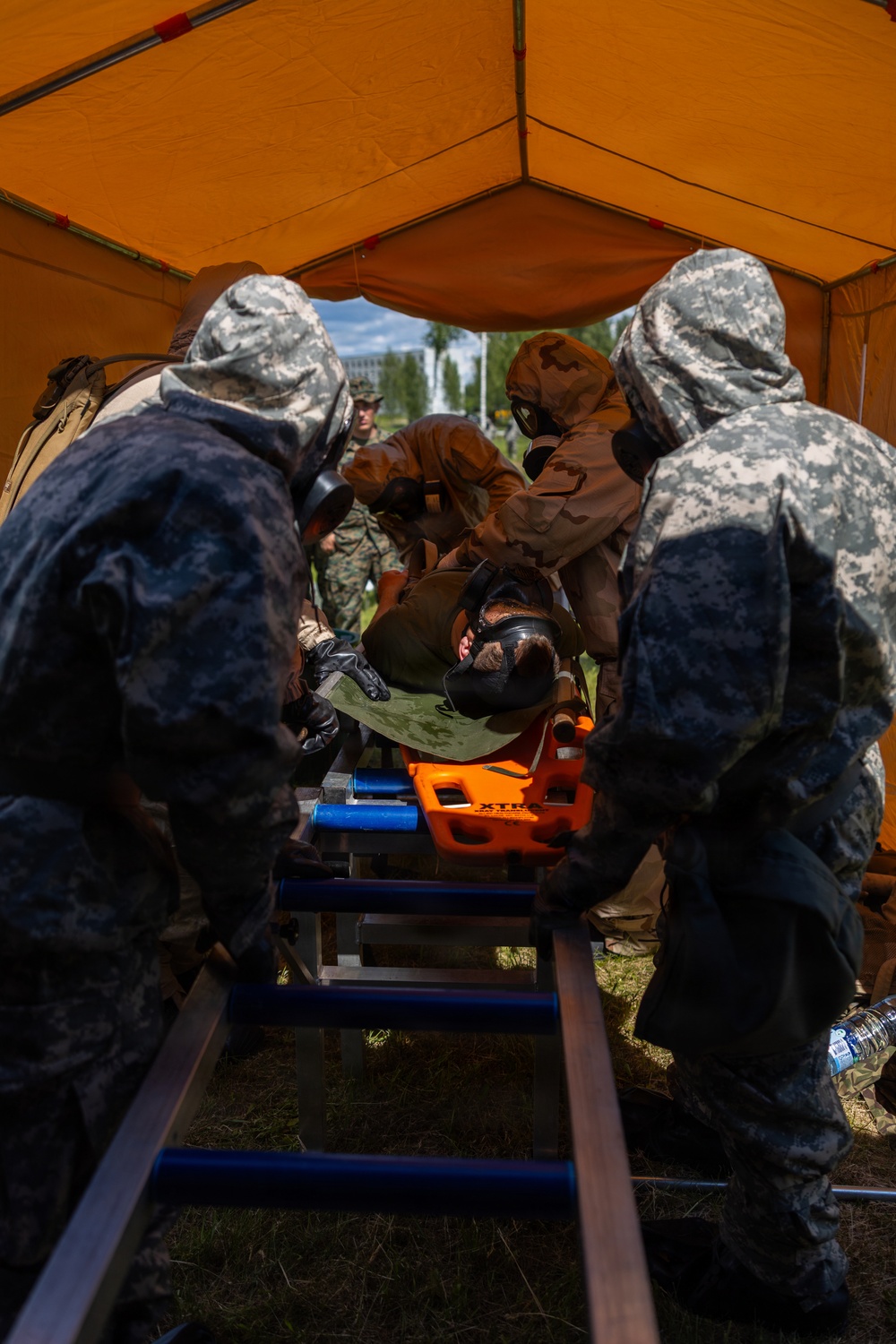 U.S. Marines and Latvian soldiers conduct a decontamination zone in the Baltic region