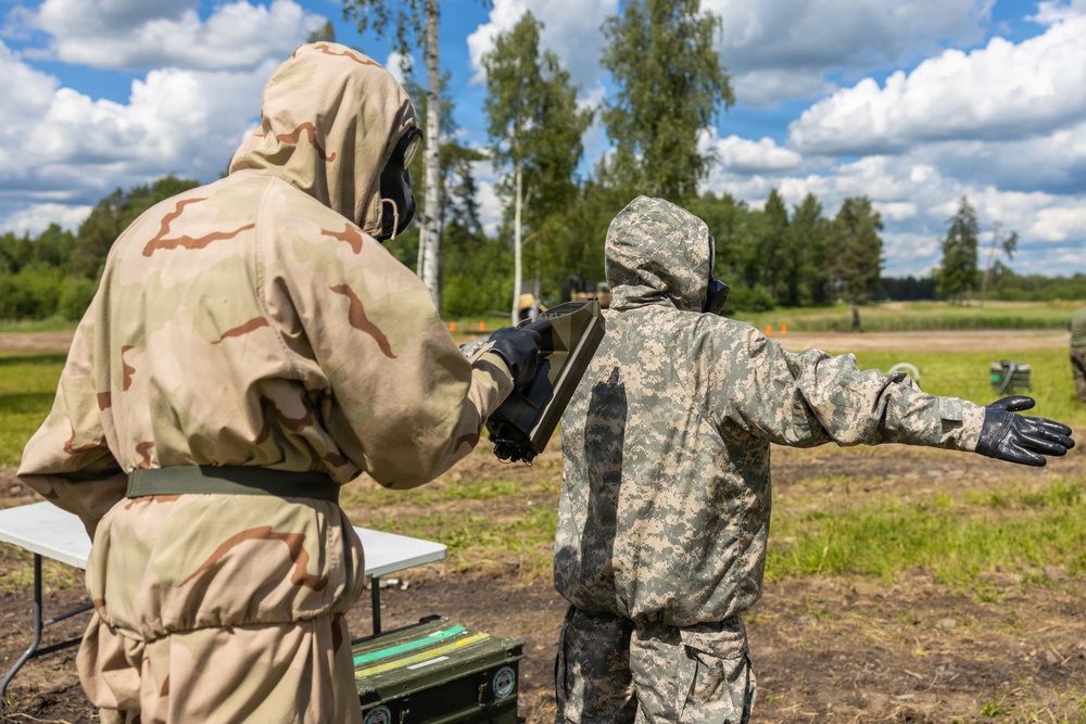 U.S. Marines and Latvian soldiers conduct a decontamination zone in the Baltic region