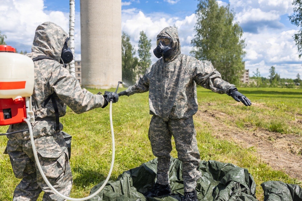U.S. Marines and Latvian soldiers conduct a decontamination zone in the Baltic region