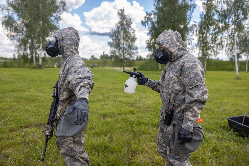 U.S. Marines and Latvian soldiers conduct a decontamination zone in the Baltic region