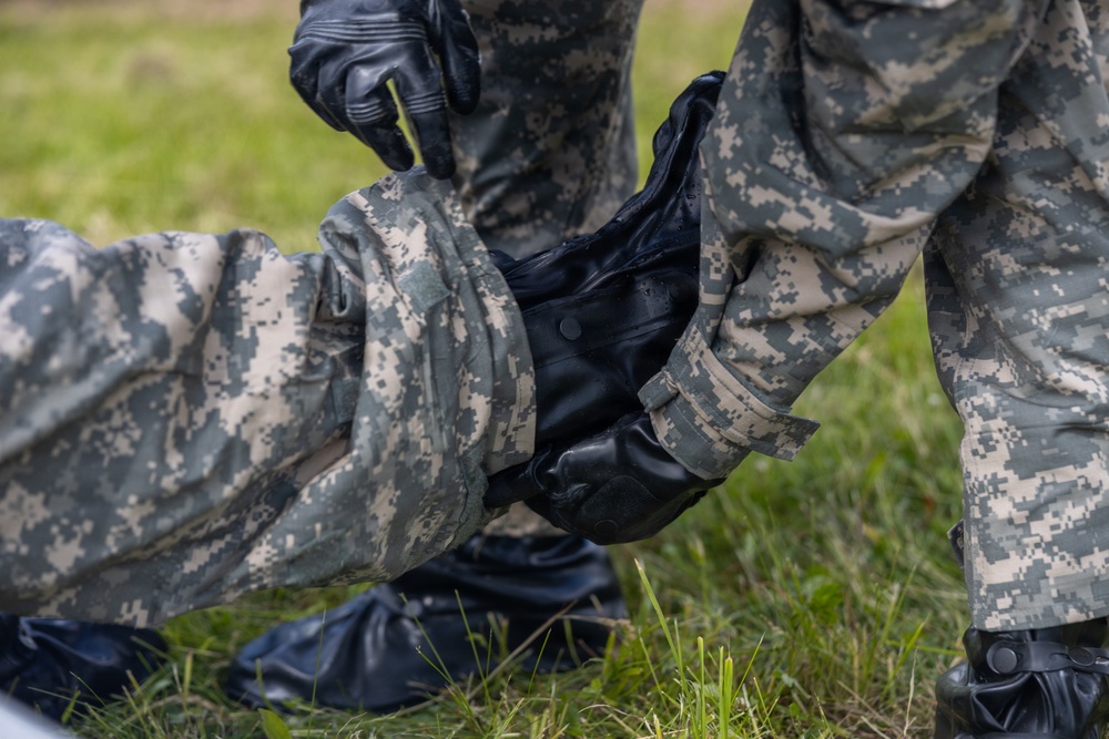 U.S. Marines and Latvian soldiers conduct a decontamination zone in the Baltic region