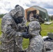 U.S. Marines and Latvian soldiers conduct a decontamination zone in the Baltic region