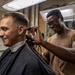 USS Ross Sailor cuts hair in the barbershop