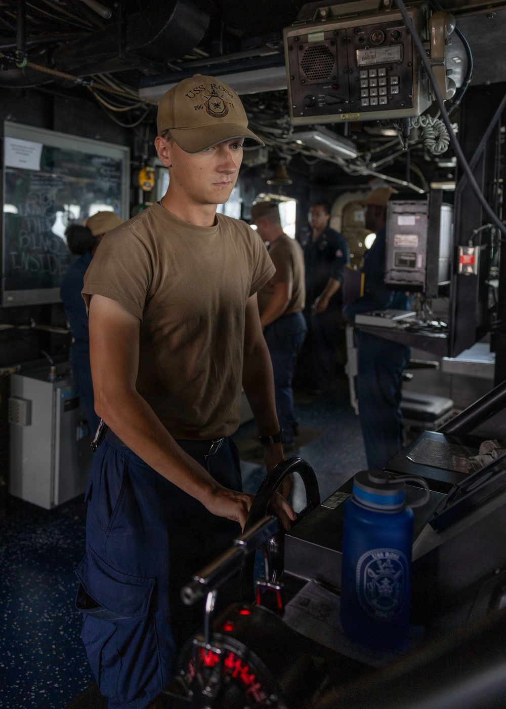 USS Ross Sailor serves as a helmsman