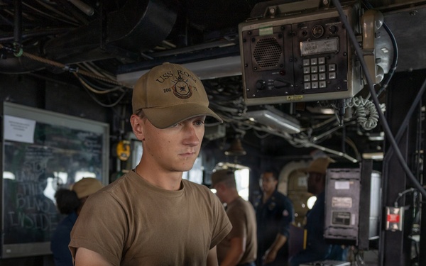USS Ross Sailor serves as a helmsman