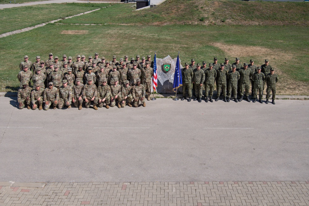 Iowa National Guard and Kosovo Security Force communication airmen and soldiers pose for group photo