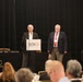 Speaker addresses attendees at SAVE organization conference luncheon