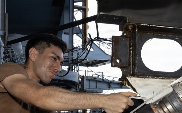 USS George H.W. Bush Sailor attaches a fueling hose