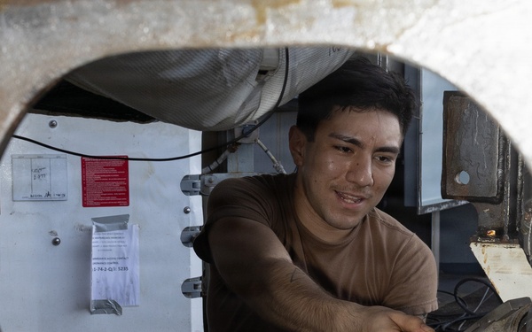 USS George H.W. Bush Sailor attaches a fueling hose